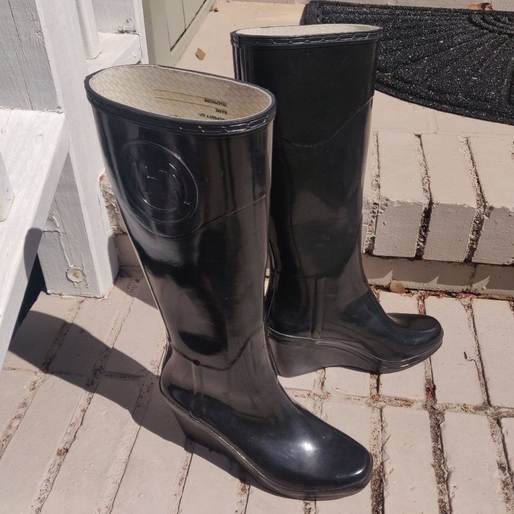 Glossy, dressy Hunter tall black wedge rain boots
